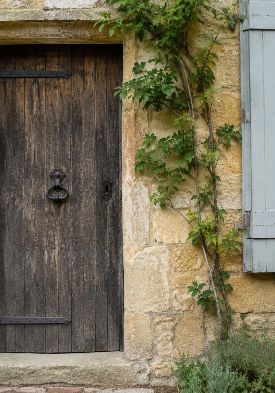 An old oak door set in a limestone wall